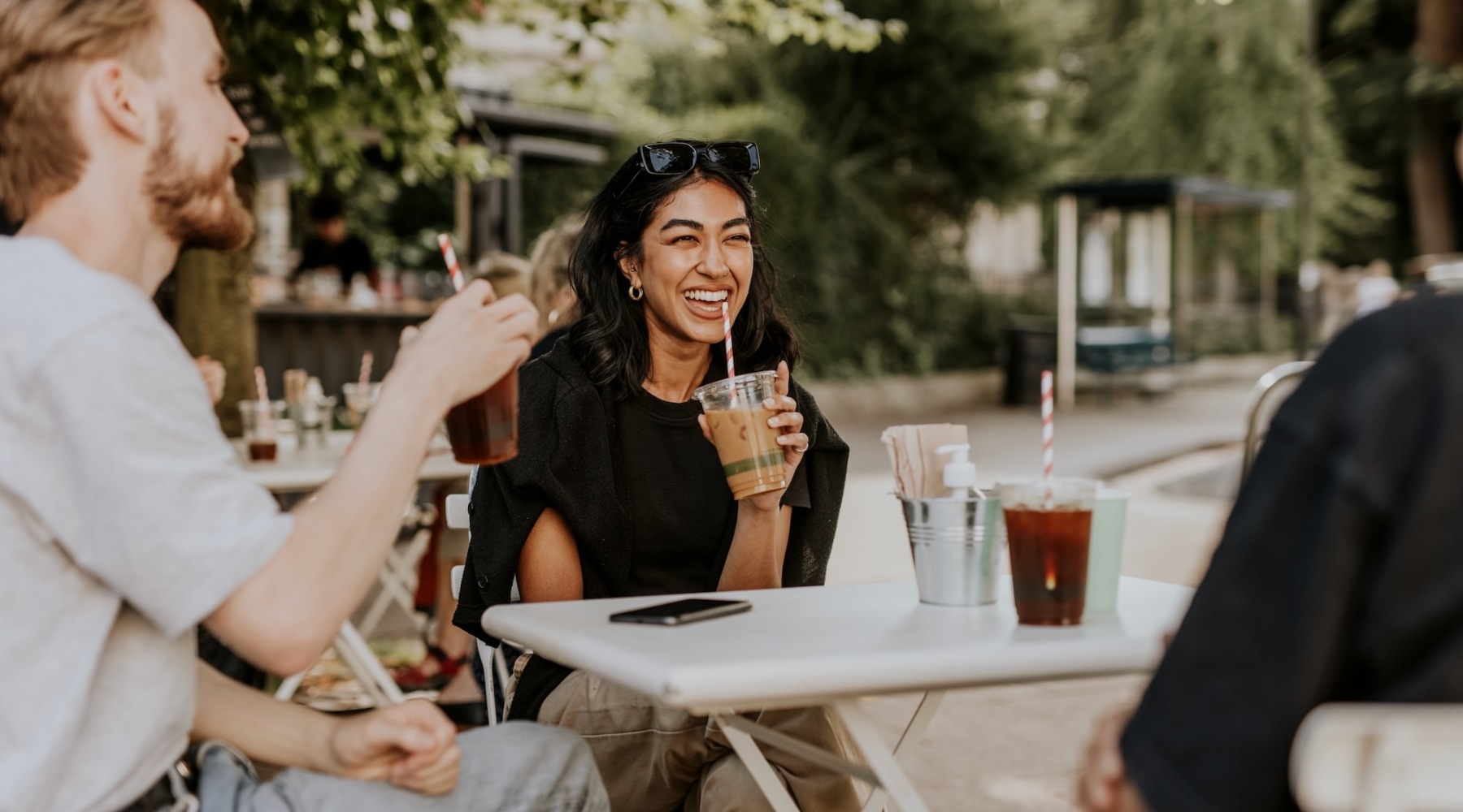 a group of people sitting at a table outside