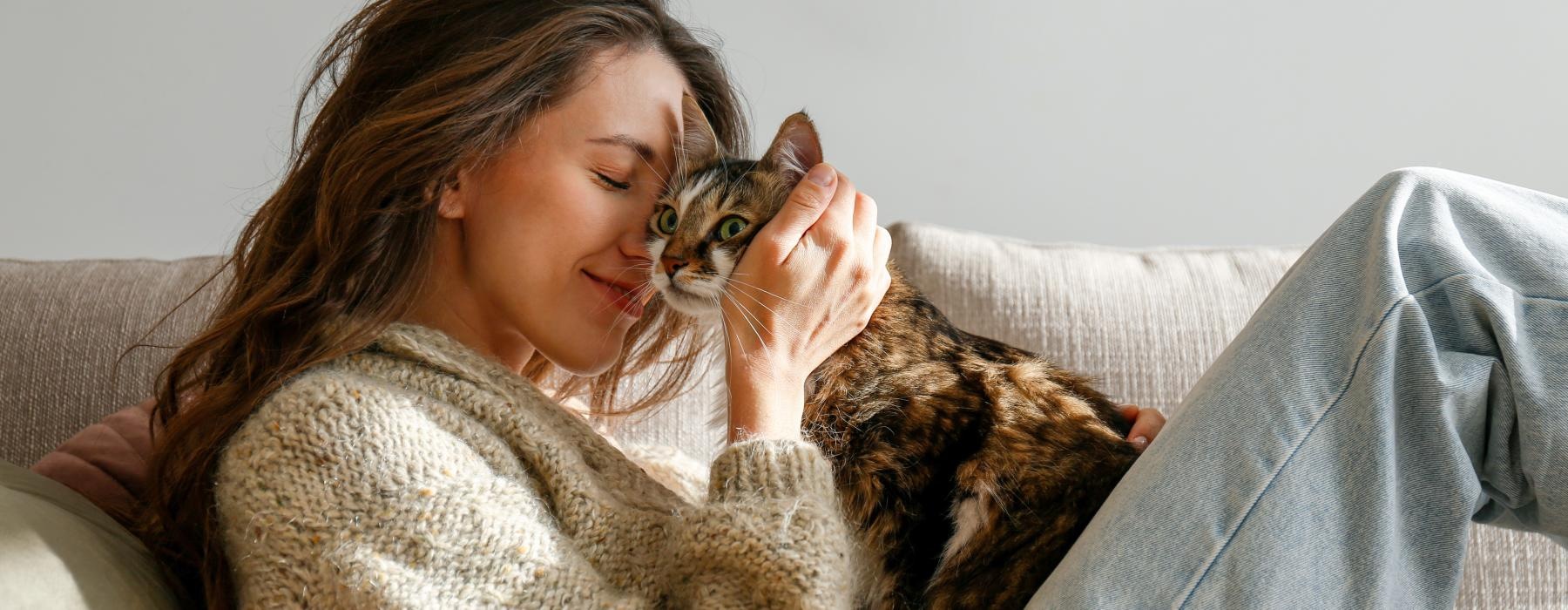 a woman lying on a couch with a cat